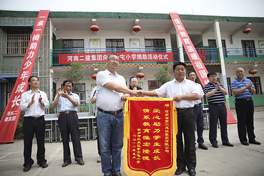 李士屯小學校長張保林回贈錦旗表示感謝